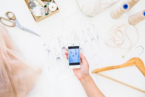 female-designer-taking-photography-fashion-sketch-smartphone_23-2147875024