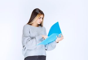 girl-reading-reports-blue-folder-making-remarks_144627-67309-1