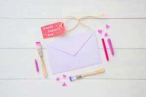 happy-mothers-day-inscription-with-envelope-paint-brushes_23-2148073652-1