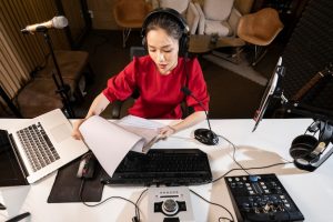 high-angle-woman-working-radio-with-professional-equipment_23-2148815364