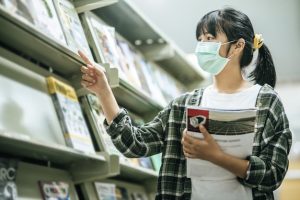 woman-wearing-mask-searching-books-library_1150-24645