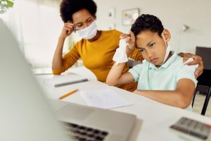 african-american-boy-feeling-stressed-out-while-homeschooling-with-mother-coronavirus-epidemic_637285-9270