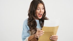 attractive-excited-brunette-girl-sweater-joyfully-opening-envelope-with-exam-results-camera-isolated_574295-1654