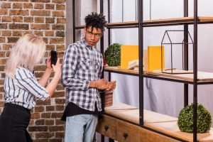 blonde-young-woman-taking-photo-her-boyfriend-cellphone_23-2148151847