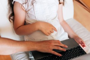 close-up-girl-with-parent-looking-laptop_23-2148254217