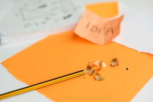 close-up-pencil-pencil-shaving-orange-paper_23-2148245937