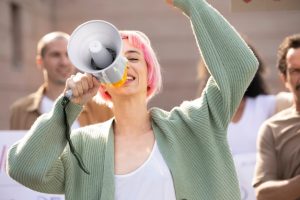 close-up-woman-holding-megaphone_23-2149163191-1