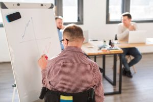 disabled-worker-presenting-project-colleagues_23-2148483912