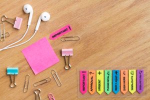 earphones-with-stationery-located-wooden-table_23-2148225495