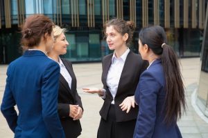 female-business-team-discussing-project-outdoors-businesswomen-wearing-suits-standing-together-city-talking-communication-teamwork-concept_74855-7239