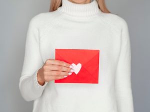 female-holding-adorable-valentine-envelope_23-2148370009