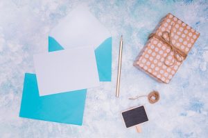 flat-lay-with-blue-envelope-birthday-invitation-mock-up_23-2148239159