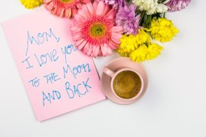 fresh-flowers-near-paper-with-words-cup-drink_23-2148077942