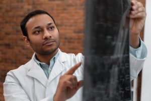 front-view-doctor-holding-radiography_23-2150165469