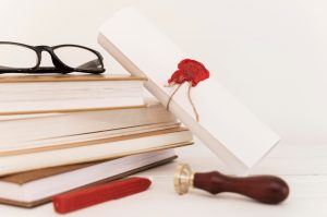 graduation-diploma-certificate-pile-books_23-2148769716