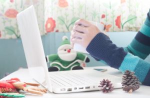 hands-holding-cup-coffee-using-laptop-with-christmas-decoration-shopping-online_1428-561