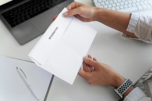 hands-holding-resignation-letter-high-angle_23-2149480577