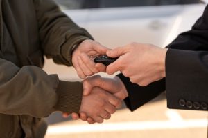 high-angle-hands-holding-car-key_23-2150321011