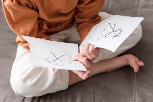 high-angle-kid-holding-broken-drawing_23-2148558416