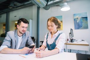 man-woman-using-smartphones-office_23-2147707732