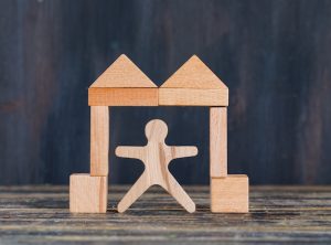 marketing-concept-with-wooden-figure-blocks-gate-shape-wooden-grunge-background-side-view_176474-7803