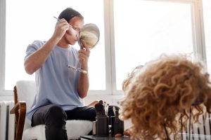 medium-shot-drag-queen-putting-makeup_23-2149434548