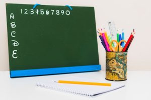notebook-pencils-near-chalkboard_23-2147846247