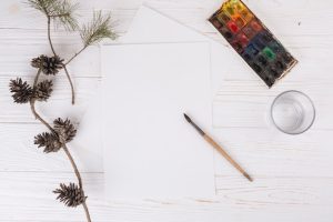 papers-near-glass-brush-twigs-water-colours_23-2148036964