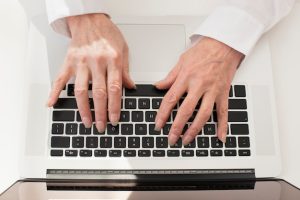 person-typing-laptop-top-view_23-2148341542