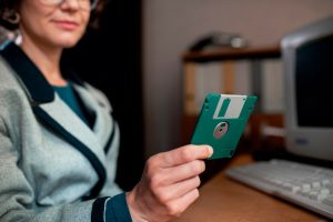 person-working-desk-vintage-90-s-style-office_23-2149851047