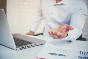 portrait-young-business-man-sitting-his-desk_1150-7698