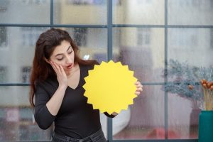 portrait-young-shocked-girl-holding-idea-bubble-looking-it_144627-76754