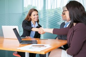 red-haired-hr-manager-greeting-employee-conference-room_74855-10219