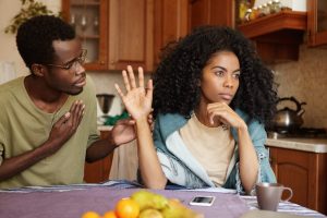 regretful-unhappy-young-african-american-male-glasses-trying-hard-sweet-talk-his-mad-offended-wife-who-is-sitting-him-kitchen-table-refusing-all-his-lies-people-relationships_273609-634