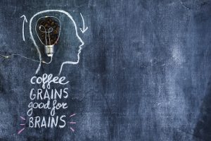 roasted-coffee-beans-light-bulb-inside-outline-face-with-arrows-chalkboard_23-2147874115