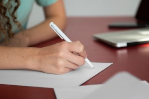 side-view-woman-writing-letter_23-2149887852