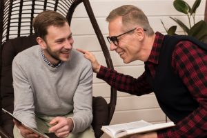 smiley-son-showing-father-something-tablet_23-2148414876