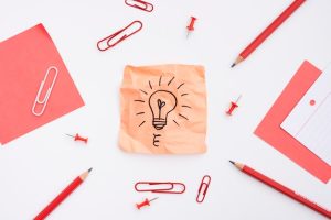 sticky-note-with-drawn-light-bulb-office-supplies-white-background_23-2148245971