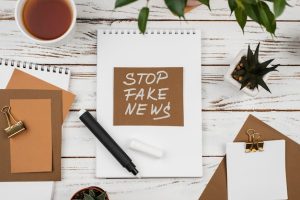 stop-fake-news-concept-with-desk_23-2148873209