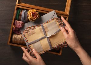 top-view-hand-holding-love-letter_23-2150716564