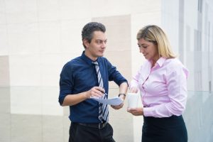 two-content-office-employees-reviewing-document_1262-12560