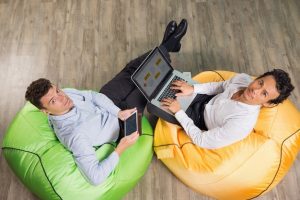 two-serious-adult-men-working-laptop-tablet_1262-1225