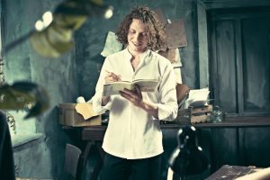 writer-work-handsome-young-writer-standing-near-table-making-up-something-his-mind_155003-15690