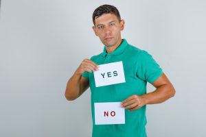 young-man-green-t-shirt-holding-paper-sheets-with-answers-looking-serious-front-view_176474-10087