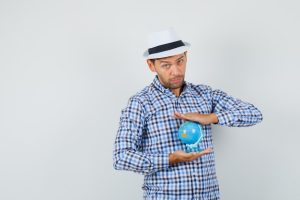 young-man-holding-world-globe-checked-shirt_176474-24167