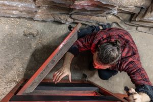 young-man-looking-into-solid-fuel-boiler-working-with-biofuels-economical-heating-top-view_169016-14806