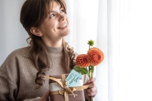 young-woman-with-gift-mothers-day-bouquet-flowers-her-hands_169016-18225