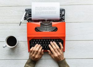 aerial-view-man-typing-retro-typewriter_53876-40994-2