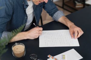 close-up-man-writing-letter_23-2148935055-2