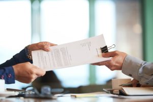 closeup-hands-passing-contract-unrecognizable-businessman_1098-19612